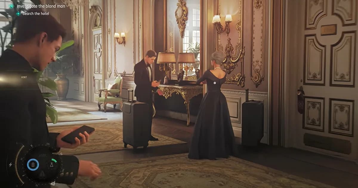 A hotel lobby with guests standing beside their luggage while a man checks his phone in the foreground.